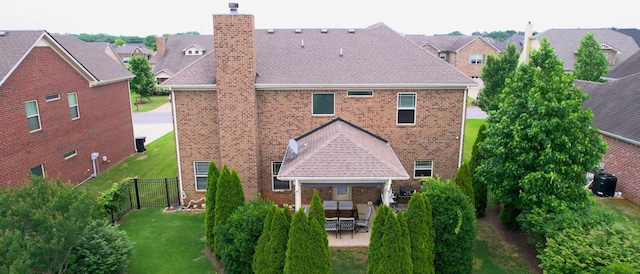 5127 Heroes Ln, Murfreesboro, TN 37129 - back of house with brick siding, a chimney, and a patio area