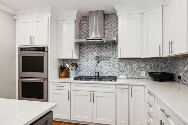 303 Avondale Dr, Franklin, TN 37064 - kitchen with wall chimney range hood, stainless steel appliances, backsplash, and white cabinets
