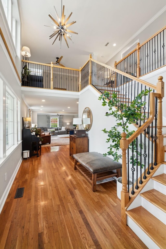 303 Avondale Dr, Franklin, TN 37064 - stairs featuring hardwood / wood-style floors, a towering ceiling, plenty of natural light, crown molding, and baseboards