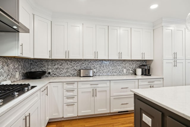 303 Avondale Dr, Franklin, TN 37064 - kitchen featuring wall chimney exhaust hood, stainless steel gas stovetop, white cabinets, backsplash, and recessed lighting