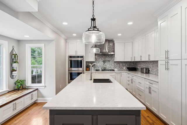 303 Avondale Dr, Franklin, TN 37064 - kitchen featuring wall chimney range hood, double oven, tasteful backsplash, light wood-style flooring, and recessed lighting