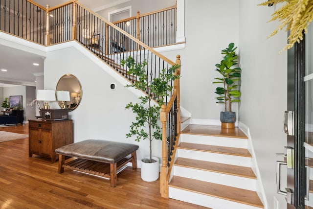 303 Avondale Dr, Franklin, TN 37064 - stairway featuring wood finished floors, ornamental molding, baseboards, a towering ceiling, and recessed lighting