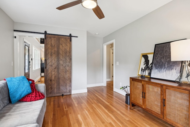 303 Avondale Dr, Franklin, TN 37064 - living room with ceiling fan, light wood-style floors, baseboards, and a barn door