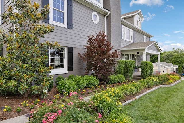 303 Avondale Dr, Franklin, TN 37064 - view of home's exterior featuring a porch, brick siding, and a lawn