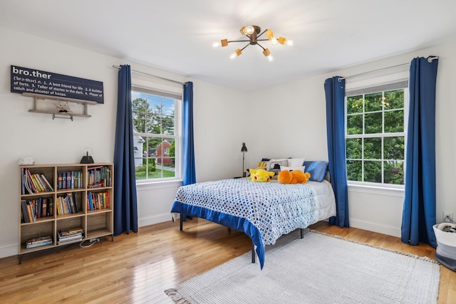 303 Avondale Dr, Franklin, TN 37064 - bedroom with a chandelier, wood finished floors, and baseboards