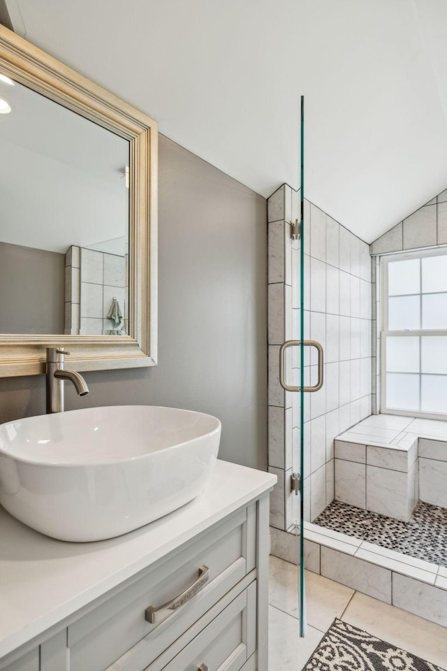 303 Avondale Dr, Franklin, TN 37064 - full bathroom featuring vaulted ceiling, a shower stall, vanity, and tile patterned flooring