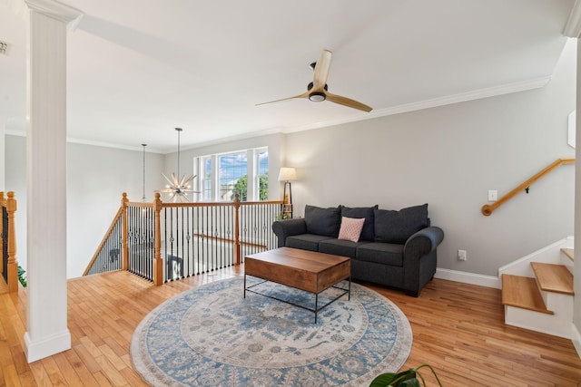 303 Avondale Dr, Franklin, TN 37064 - living area with light wood-type flooring, a ceiling fan, crown molding, baseboards, and a chandelier