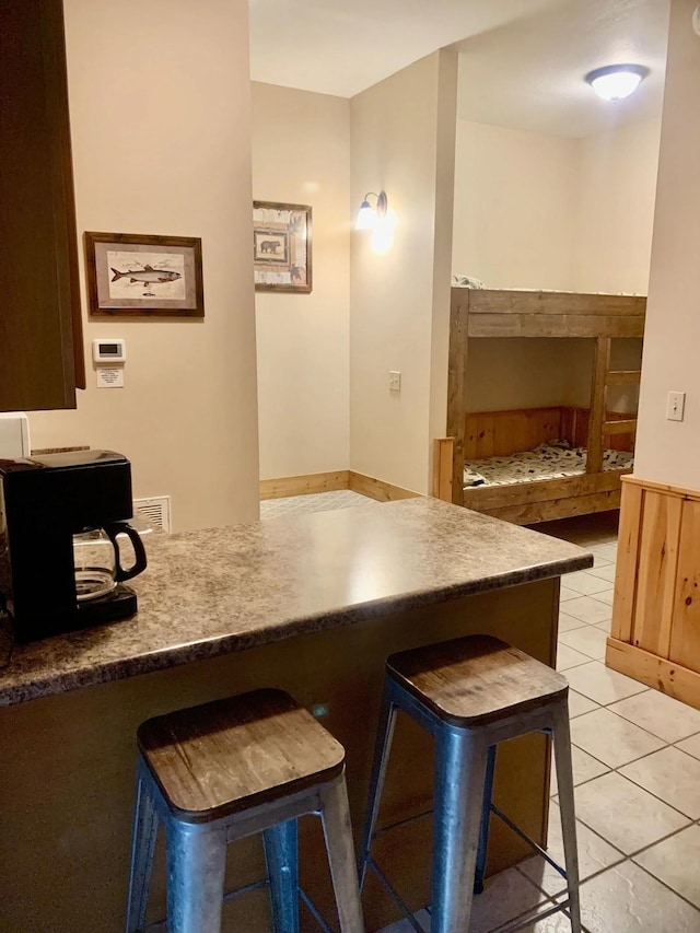839 Golf View Blvd, Pigeon Forge, TN 37863 - kitchen with a breakfast bar area and light tile patterned floors