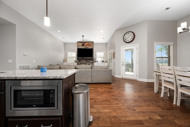 2743 Crowne Pointe Dr, Murfreesboro, TN 37130 - kitchen featuring stainless steel microwave, dark wood finished floors, light stone counters, and lofted ceiling