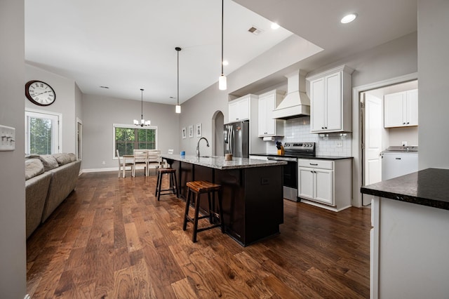 2743 Crowne Pointe Dr, Murfreesboro, TN 37130 - kitchen featuring appliances with stainless steel finishes, custom range hood, a sink, dark wood-style flooring, and a kitchen breakfast bar