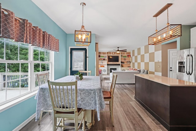 1514 Cardinal Ln, Mount Juliet, TN 37122 - dining space with ceiling fan, baseboards, a chandelier, a fireplace, and wood finished floors