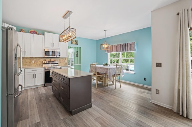 1514 Cardinal Ln, Mount Juliet, TN 37122 - kitchen with stainless steel appliances, white cabinets, light countertops, and light wood-style flooring