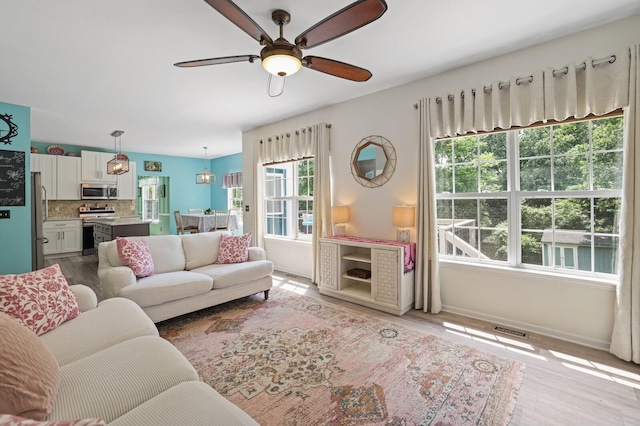 1514 Cardinal Ln, Mount Juliet, TN 37122 - living area with a ceiling fan, baseboards, and light wood-style flooring