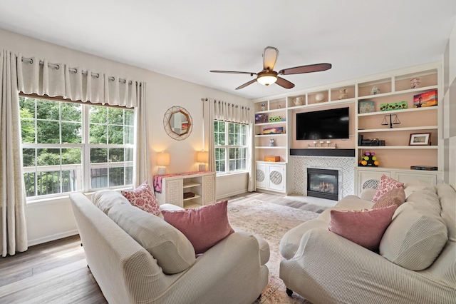 1514 Cardinal Ln, Mount Juliet, TN 37122 - living room with a tiled fireplace, wood finished floors, a ceiling fan, and baseboards