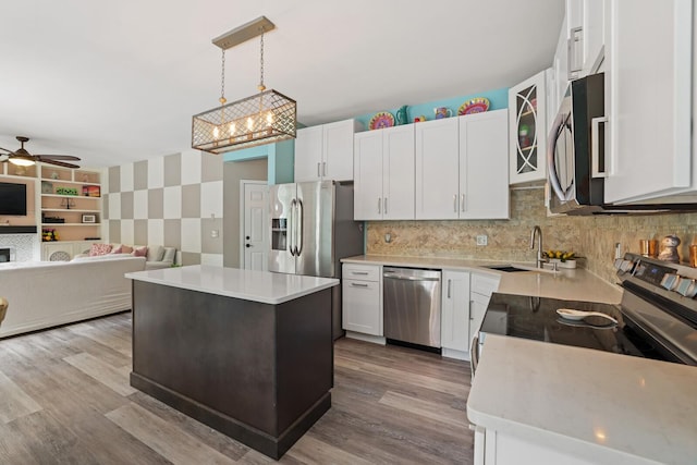 1514 Cardinal Ln, Mount Juliet, TN 37122 - kitchen with stainless steel appliances, a sink, open floor plan, light countertops, and white cabinetry