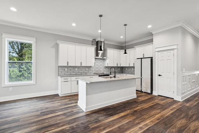 1904 Manchester Ave, Nashville, TN 37218 - kitchen with freestanding refrigerator, wall chimney range hood, dark wood-style flooring, a sink, and an island with sink