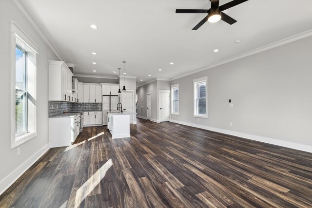 1904 Manchester Ave, Nashville, TN 37218 - kitchen with open floor plan, a center island with sink, a sink, a ceiling fan, and decorative backsplash