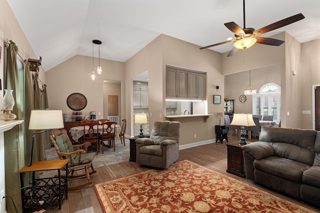 3006 Gracie Ann Dr, Greenbrier, TN 37073 - living room featuring wood finished floors, ceiling fan, high vaulted ceiling, baseboards, and a chandelier