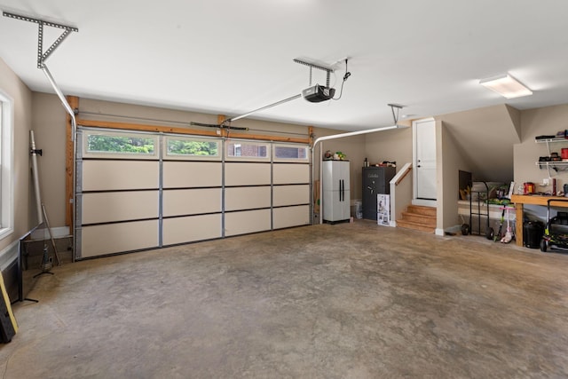 3006 Gracie Ann Dr, Greenbrier, TN 37073 - garage featuring freestanding refrigerator and a garage door opener