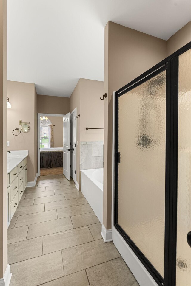 3006 Gracie Ann Dr, Greenbrier, TN 37073 - ensuite bathroom with a bath, a shower stall, double vanity, and baseboards