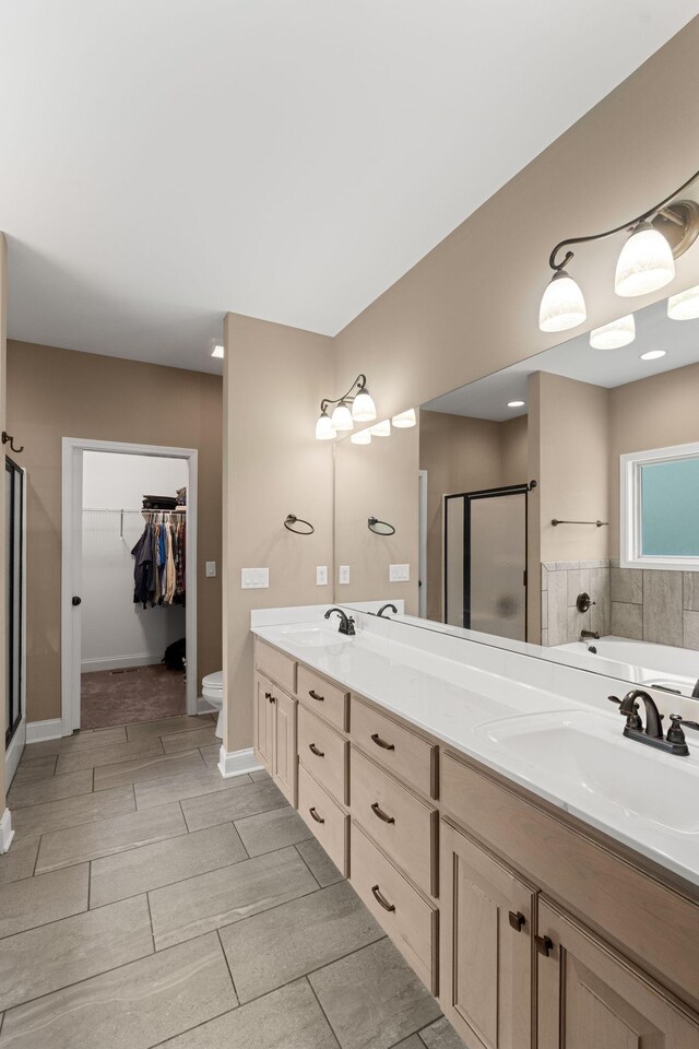 3006 Gracie Ann Dr, Greenbrier, TN 37073 - bathroom with a shower stall, double vanity, toilet, a garden tub, and a spacious closet