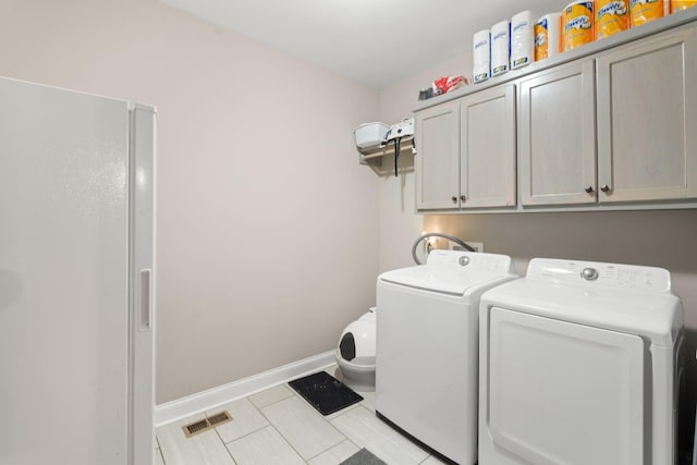 3006 Gracie Ann Dr, Greenbrier, TN 37073 - laundry room with cabinet space, washing machine and dryer, baseboards, and tile patterned floors