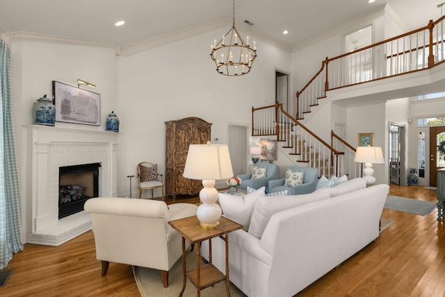 403 Butterfly Ct, Franklin, TN 37069 - living room with high vaulted ceiling, stairs, wood finished floors, ornamental molding, and a chandelier