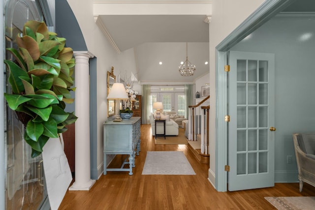 403 Butterfly Ct, Franklin, TN 37069 - foyer featuring decorative columns, vaulted ceiling, wood finished floors, a chandelier, and ornamental molding