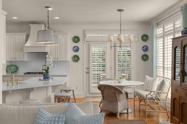 403 Butterfly Ct, Franklin, TN 37069 - dining area featuring healthy amount of natural light, ornamental molding, and light wood-type flooring