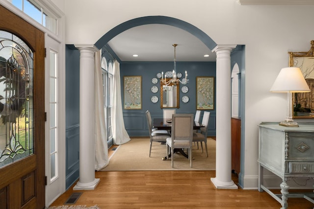 403 Butterfly Ct, Franklin, TN 37069 - entrance foyer with ornate columns, arched walkways, wood finished floors, recessed lighting, and a chandelier