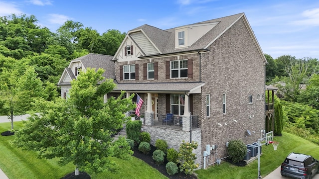 6740 Falls Ridge Ln, College Grove, TN 37046 - craftsman-style house featuring covered porch, brick siding, a front lawn, roof with shingles, and stone siding