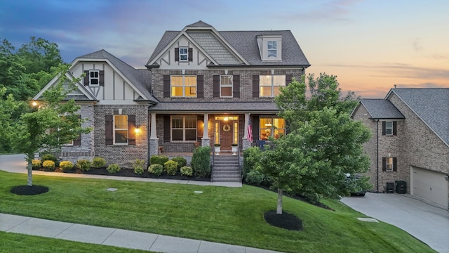 6740 Falls Ridge Ln, College Grove, TN 37046 - view of front facade with covered porch, driveway, a front lawn, and brick siding