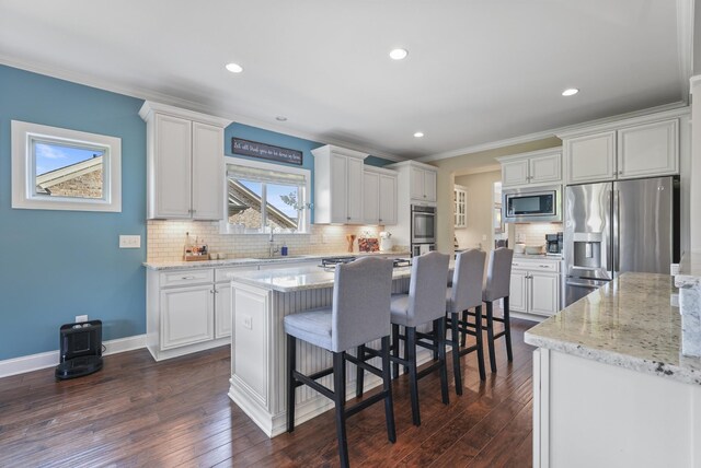 6740 Falls Ridge Ln, College Grove, TN 37046 - kitchen with appliances with stainless steel finishes, tasteful backsplash, crown molding, white cabinets, and dark wood-type flooring