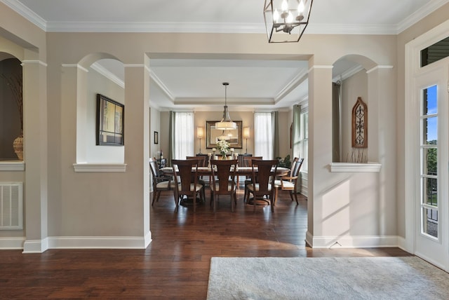 6740 Falls Ridge Ln, College Grove, TN 37046 - dining room featuring wood finished floors, a chandelier, arched walkways, baseboards, and crown molding