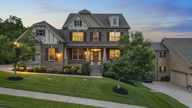 6740 Falls Ridge Ln, College Grove, TN 37046 - craftsman-style house with a porch, driveway, a front lawn, and brick siding