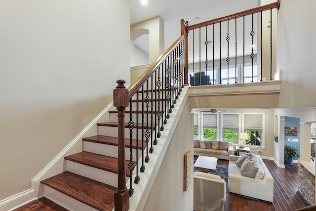 6740 Falls Ridge Ln, College Grove, TN 37046 - staircase with a towering ceiling, wood finished floors, and baseboards
