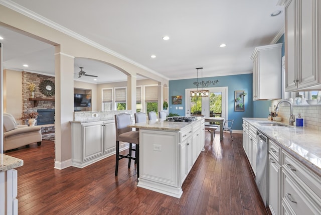 6740 Falls Ridge Ln, College Grove, TN 37046 - kitchen with a fireplace, a sink, backsplash, a center island, and light stone countertops