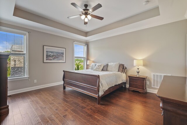 6740 Falls Ridge Ln, College Grove, TN 37046 - bedroom featuring a tray ceiling, baseboards, wood finished floors, a ceiling fan, and crown molding