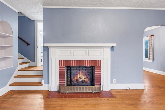 412 Cumberland St E, Cowan, TN 37318 - detailed view of a textured ceiling, wood finished floors, a fireplace, and arched walkways