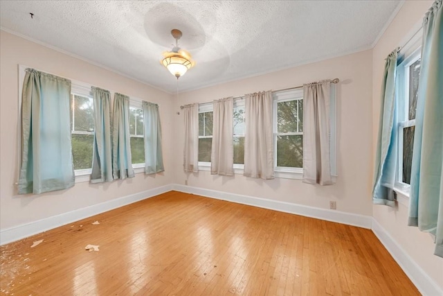 412 Cumberland St E, Cowan, TN 37318 - empty room with a textured ceiling, wood-type flooring, and ornamental molding