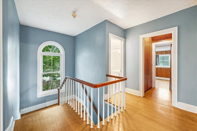 412 Cumberland St E, Cowan, TN 37318 - corridor with an upstairs landing, wood finished floors, a textured ceiling, and plenty of natural light