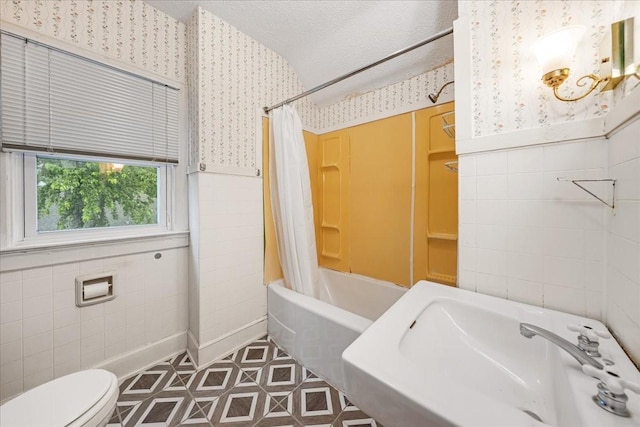 412 Cumberland St E, Cowan, TN 37318 - full bath with wallpapered walls, tile walls, and shower / bath combination with curtain