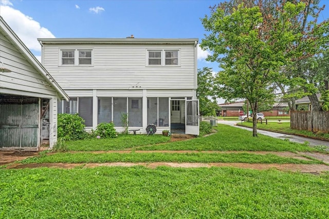 412 Cumberland St E, Cowan, TN 37318 - back of house with a sunroom and a lawn