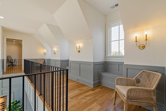 7212 Shagbark Ln, College Grove, TN 37046 - corridor with an upstairs landing, light wood-style flooring, and wainscoting