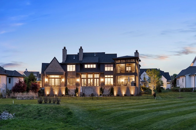 7212 Shagbark Ln, College Grove, TN 37046 - back of house at dusk with a chimney and a balcony