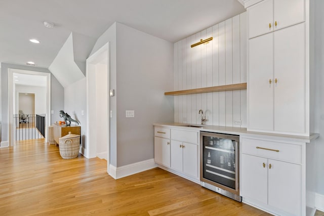 7212 Shagbark Ln, College Grove, TN 37046 - indoor wet bar featuring wine cooler, light wood finished floors, baseboards, and recessed lighting