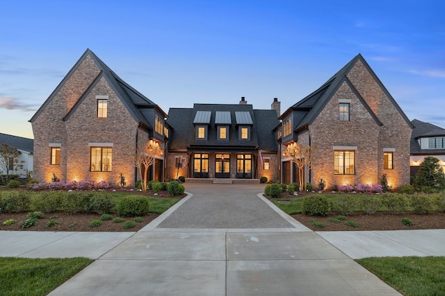 7212 Shagbark Ln, College Grove, TN 37046 - view of front of house with brick siding, a chimney, and curved driveway