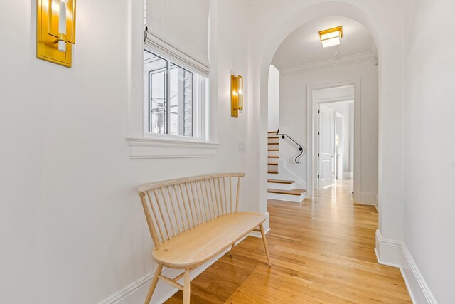 7212 Shagbark Ln, College Grove, TN 37046 - hallway featuring arched walkways, light wood-style flooring, crown molding, stairs, and baseboards