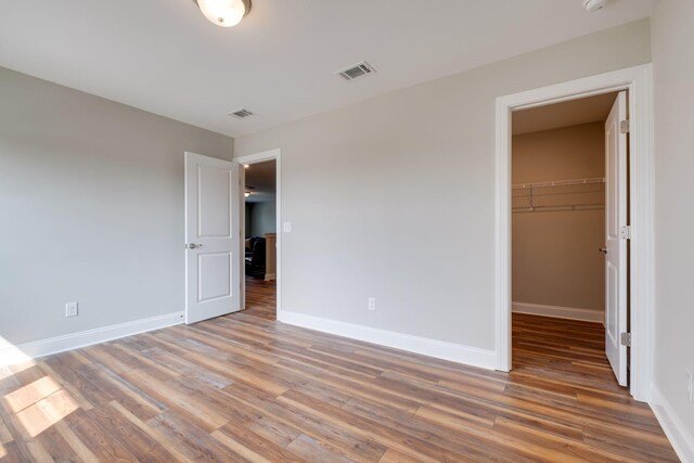 1207 Bridgett Way, Mount Juliet, TN 37122 - unfurnished bedroom featuring wood finished floors, a walk in closet, baseboards, and a closet
