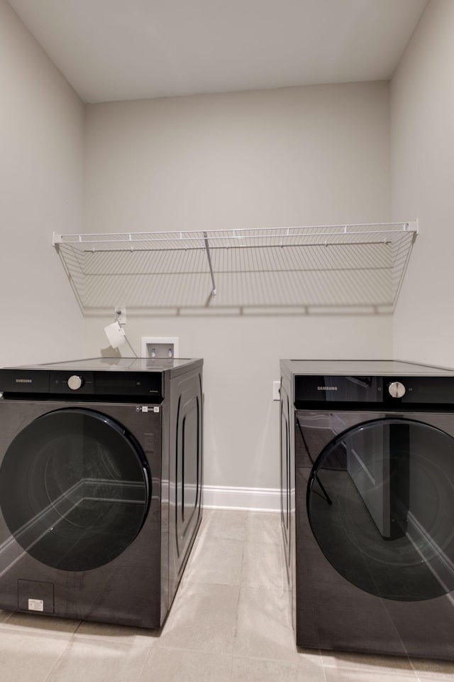 1207 Bridgett Way, Mount Juliet, TN 37122 - laundry area featuring washing machine and clothes dryer, baseboards, and light tile patterned flooring